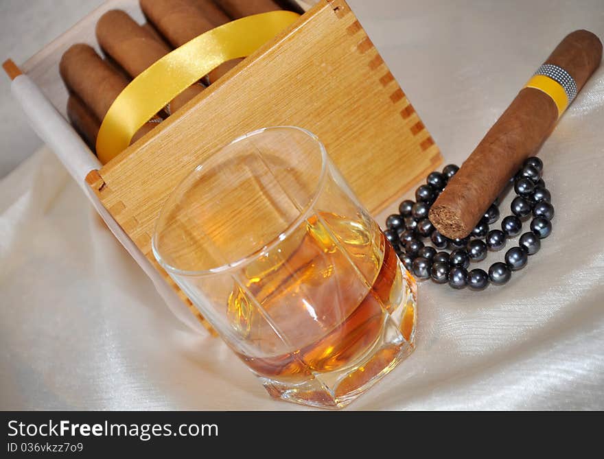 Cigars, cognac and black pearls. Cigars, cognac and black pearls.