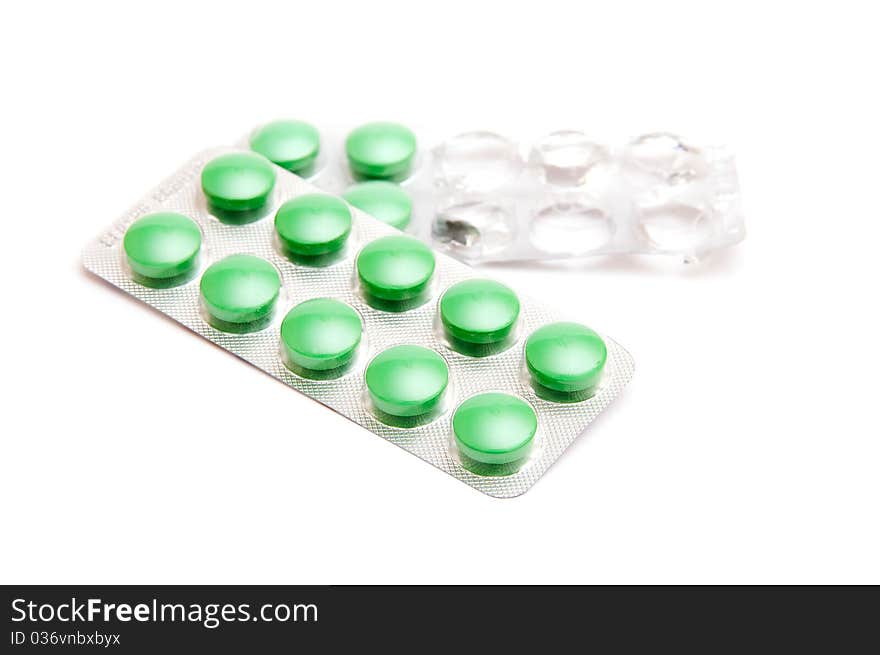 Green pills isolated on white background