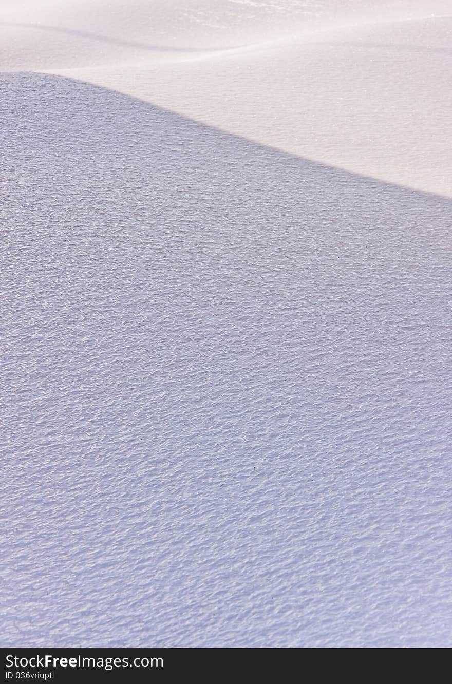 Shadows cast on an ice-crusted snow drift. Shadows cast on an ice-crusted snow drift.