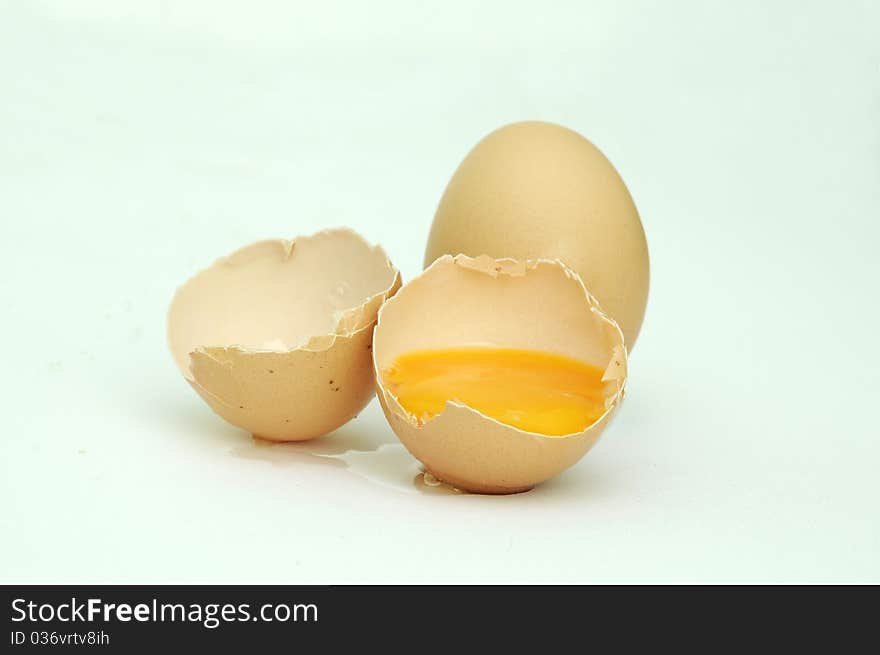 Raw broken eggs on white background. Raw broken eggs on white background.