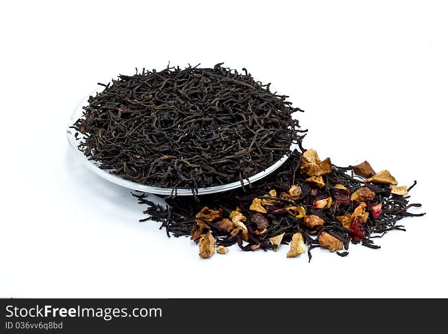 Black tea leaves with dried fruit tea on white background