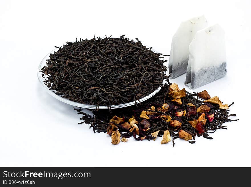 Black tea leaves with dried fruit tea on white background