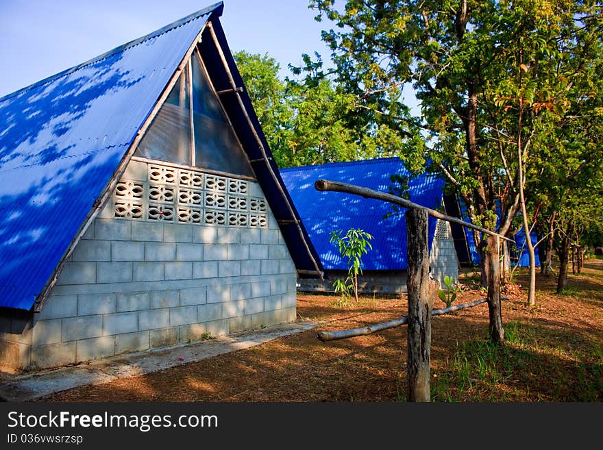 Three little blue roof camp in boy scout adventure campsite area. Three little blue roof camp in boy scout adventure campsite area