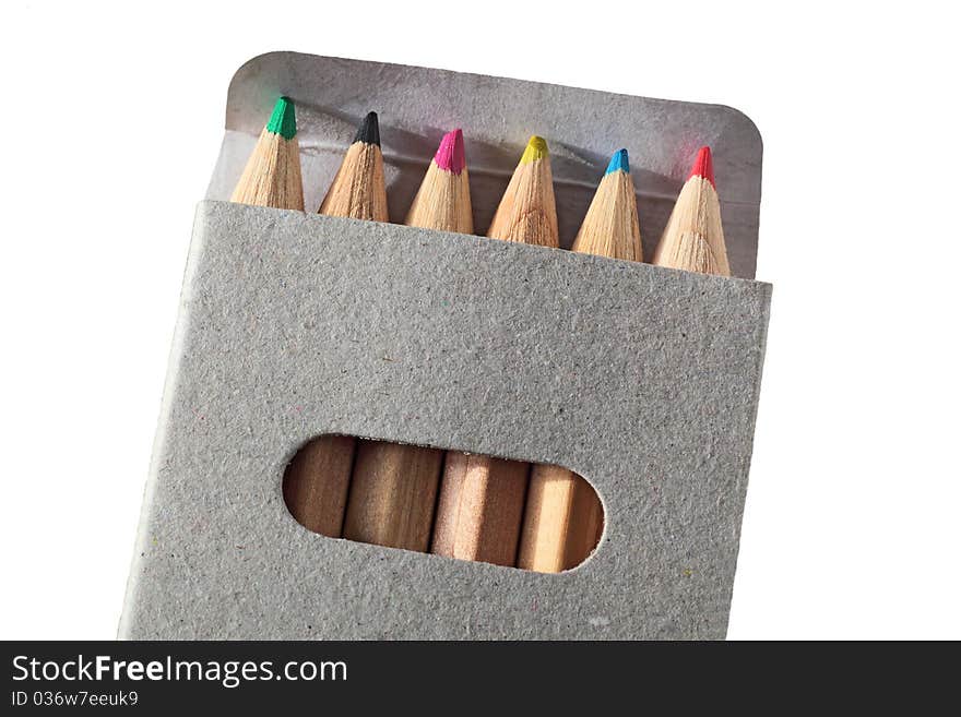 Wooden color pencils in a gray carton box isolated in white