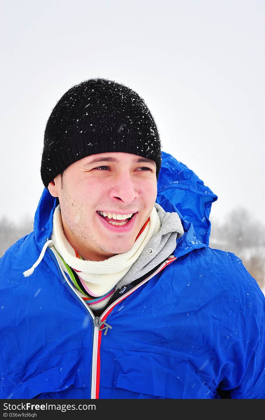 Image of a cheerful smiling man taking a walk outdoors in winter time. Image of a cheerful smiling man taking a walk outdoors in winter time