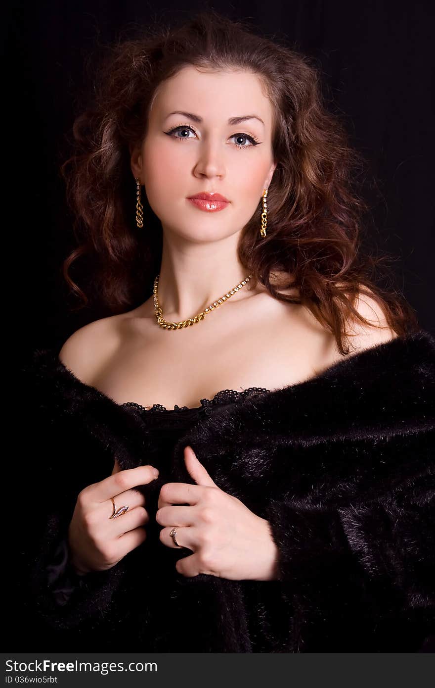 Beautiful young woman in a black fur