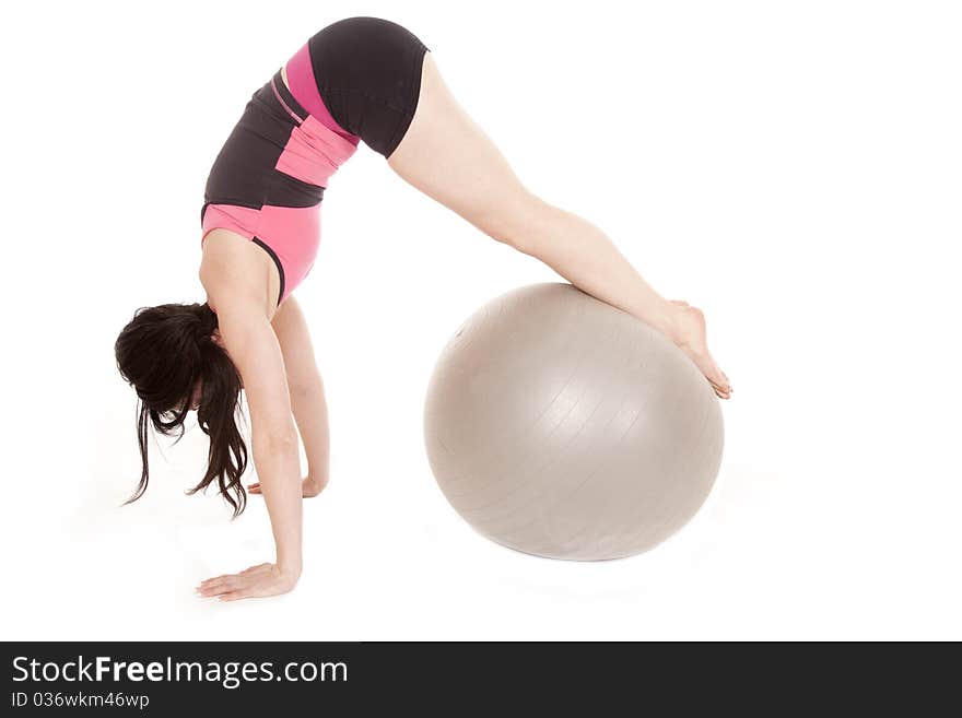 A woman is exercising with a big ball. A woman is exercising with a big ball.