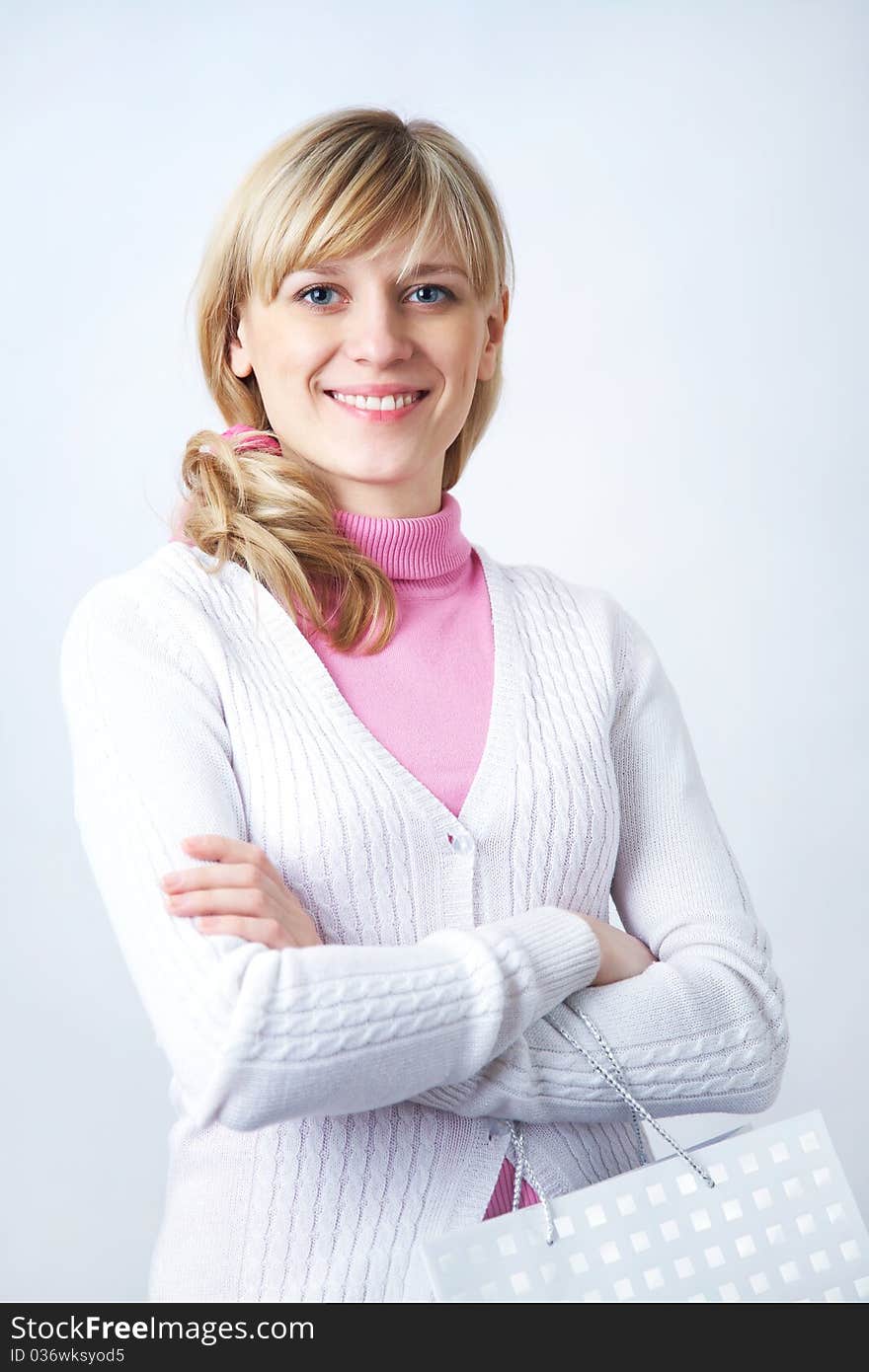 Portrait of attractive blonde woman with shopping bag on the white background. Portrait of attractive blonde woman with shopping bag on the white background