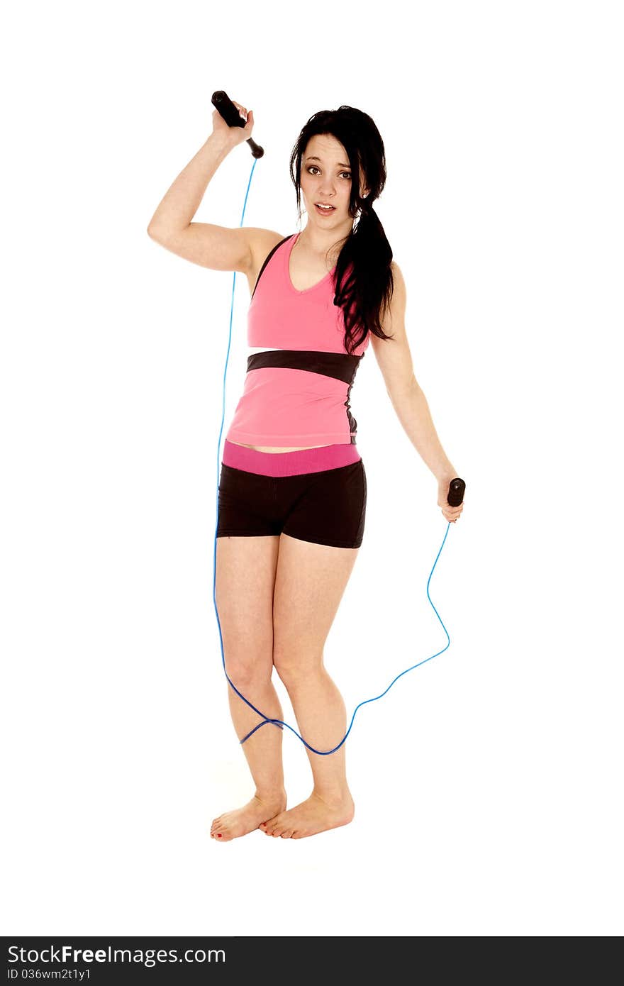 A woman is tripping on a jump rope. A woman is tripping on a jump rope.