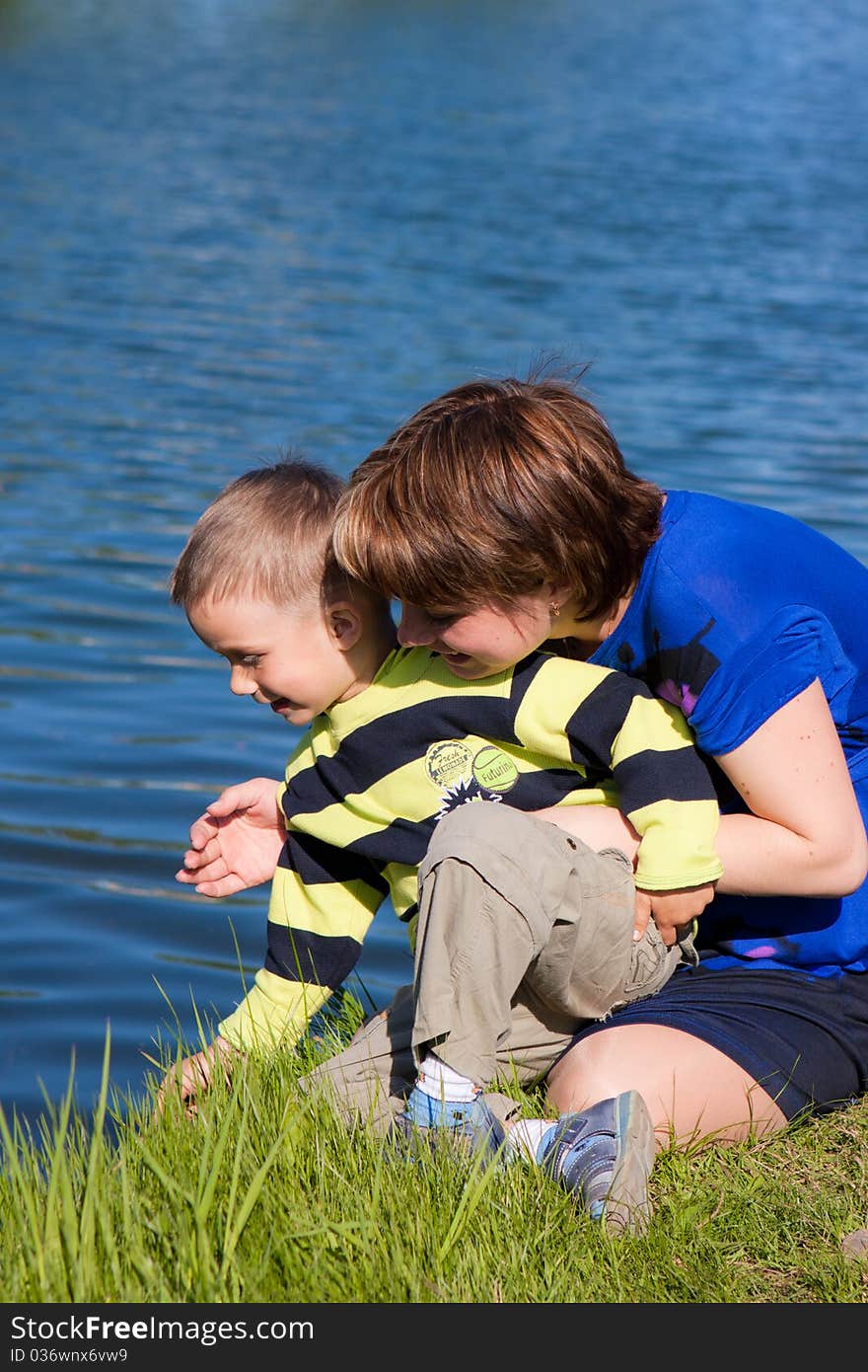 Charming Woman With A Son In Summer