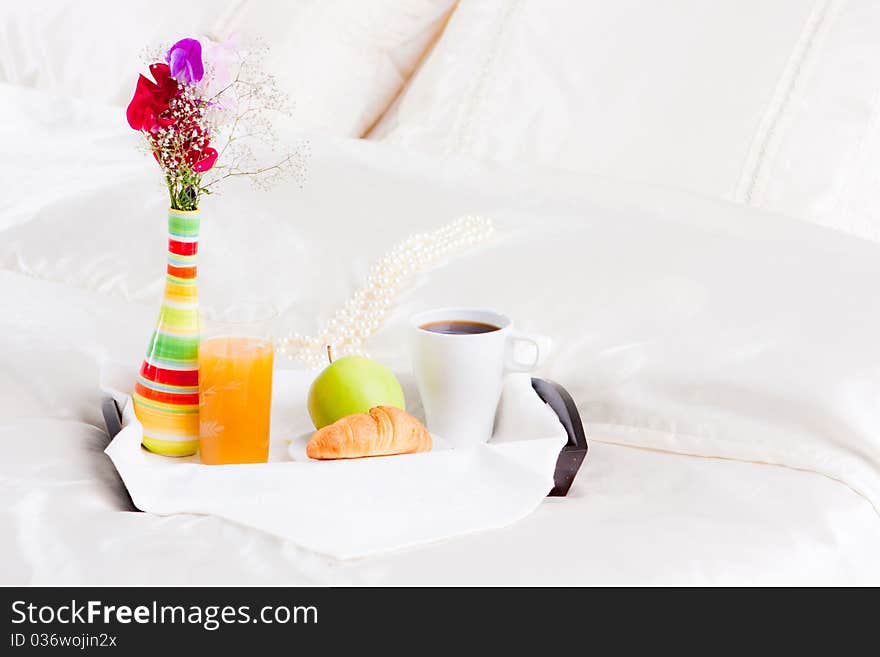 Cup of coffe and flower in vase on tray. Cup of coffe and flower in vase on tray