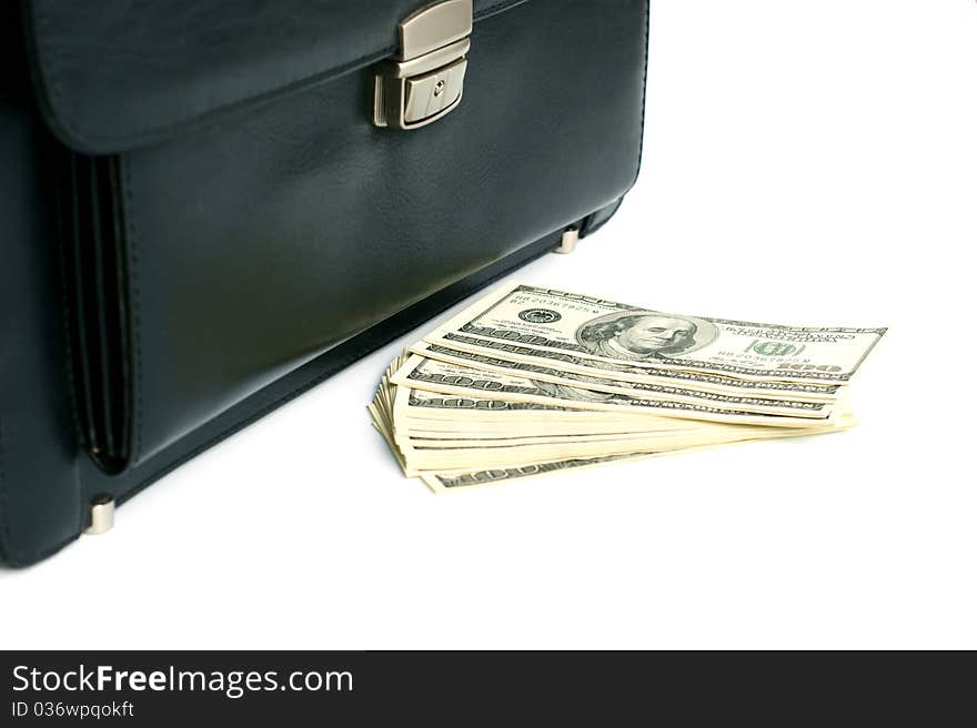 Black briefcase and money isolated on white background