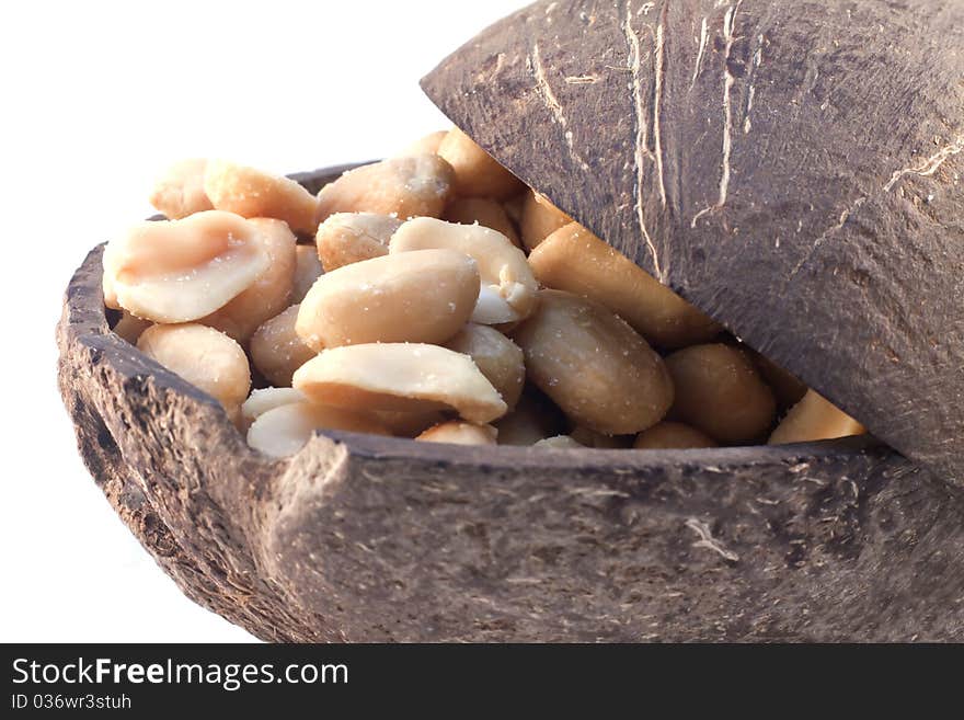 Macro picture of the coconut shell full of peanuts. Macro picture of the coconut shell full of peanuts.