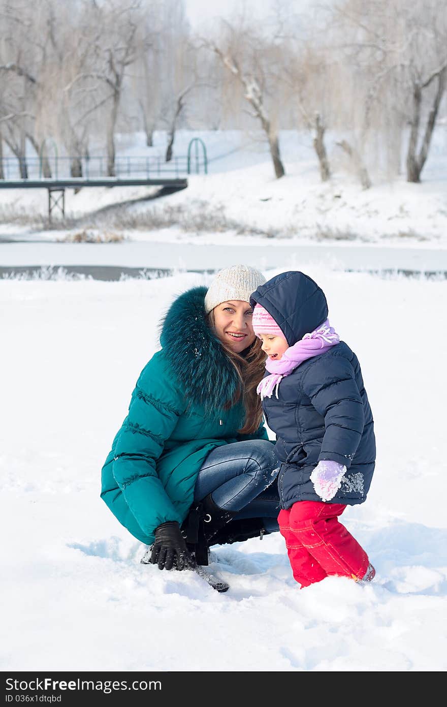 Mother and  kid having fun outdoors on beautiful winter day. Mother and  kid having fun outdoors on beautiful winter day