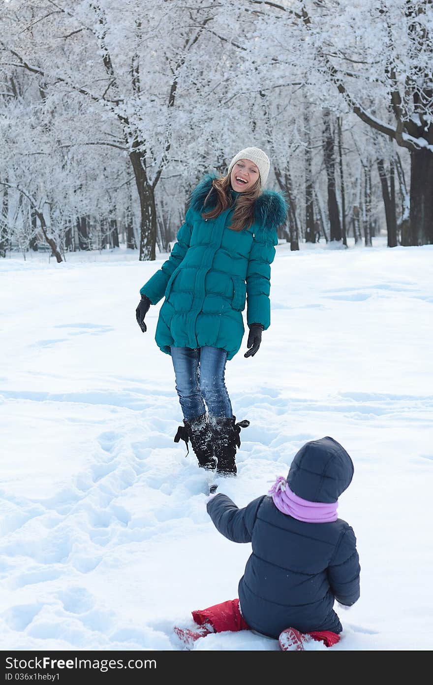 Mother and  kid having fun outdoors on beautiful winter day. Mother and  kid having fun outdoors on beautiful winter day