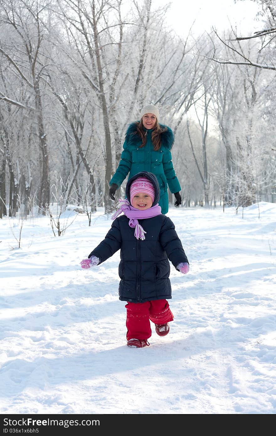 Mother and kid having fun outdoors on beautiful winter day. Mother and kid having fun outdoors on beautiful winter day