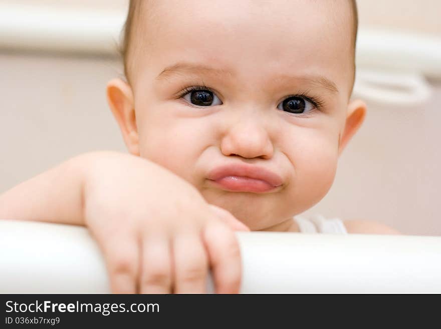 Fun caucasian baby paying the ape in manege