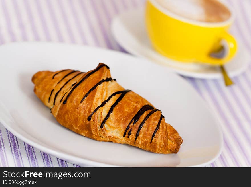 Cappuccino and chocolate croissant isolated on whi