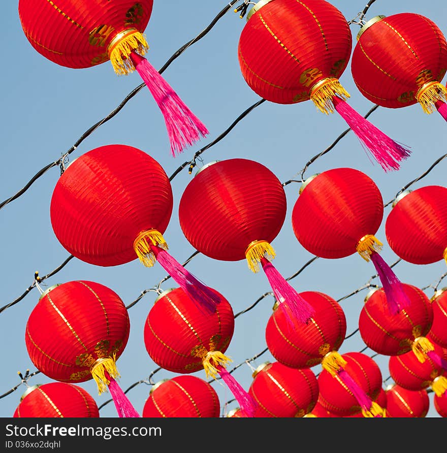 Red Chinese new year lantern and pink bob rows in front of blue sky. Red Chinese new year lantern and pink bob rows in front of blue sky.