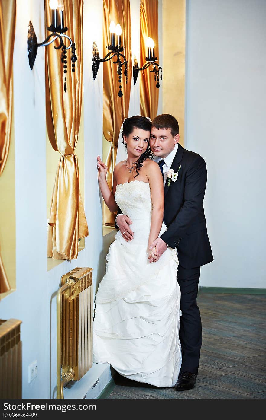 Elegant bride and groom in luxury interior