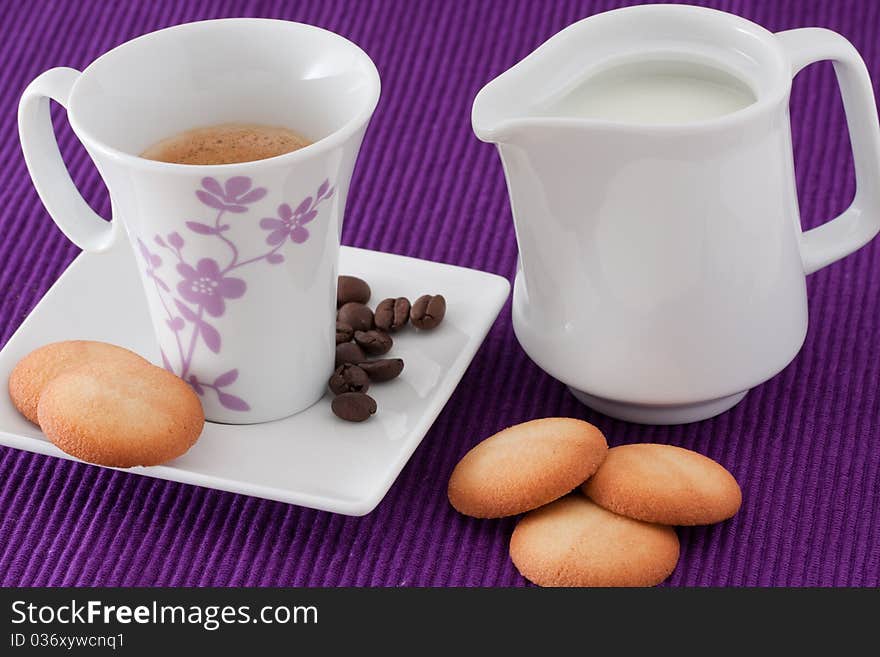 Cup of coffe, milk and biscuits