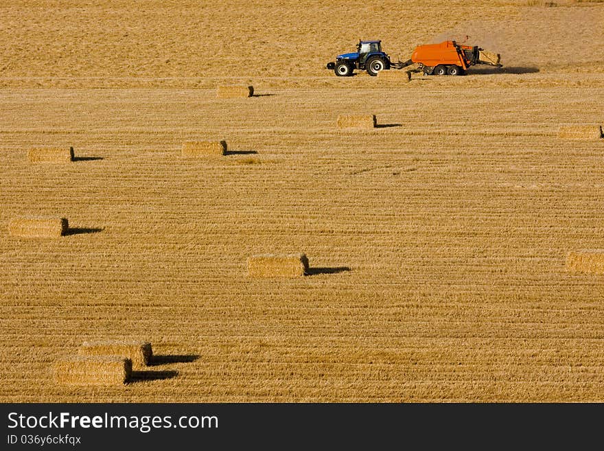 Farmer with tractor and bales