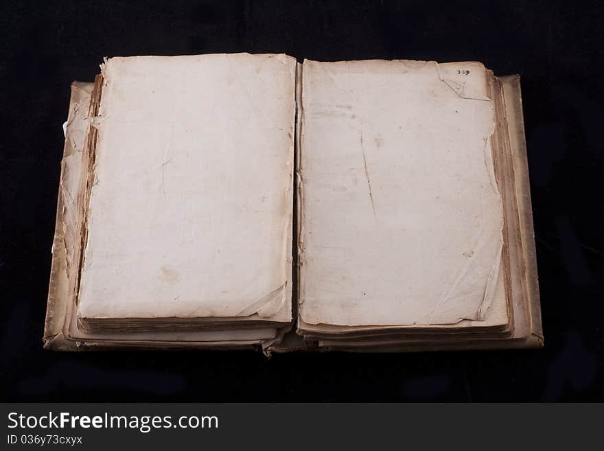 Ancient book, almost 300 years, opened on two blank sheets isolated on black