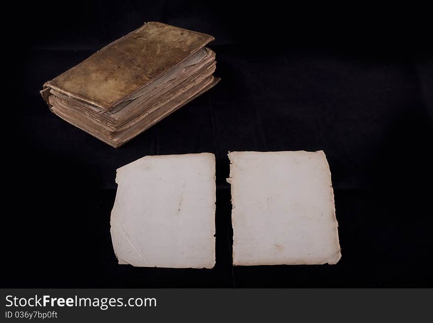 Ancient book, almost 300 years, opened on two blank sheets isolated on black