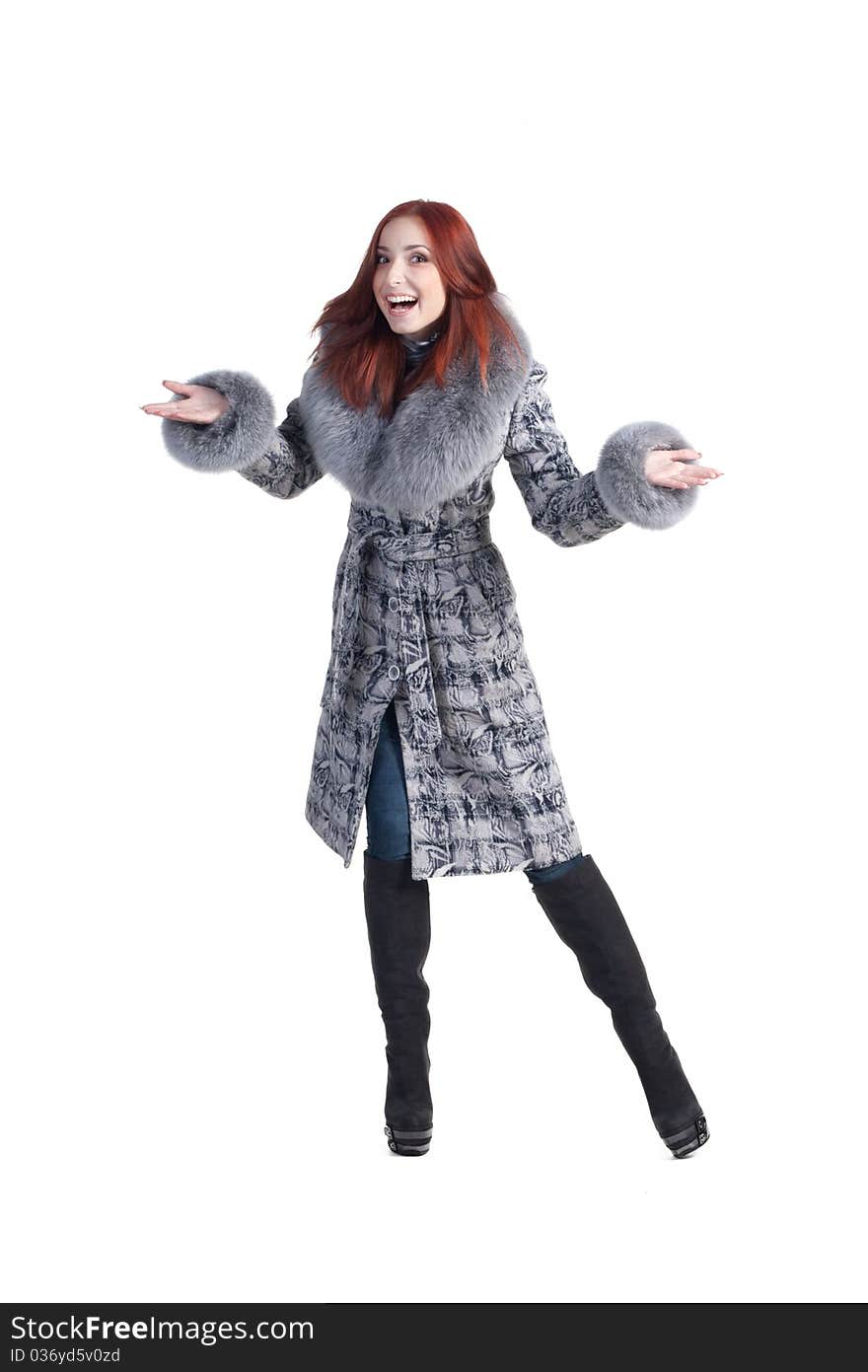 A beautiful smiling woman in a grey coat with fur isolated on white. A beautiful smiling woman in a grey coat with fur isolated on white