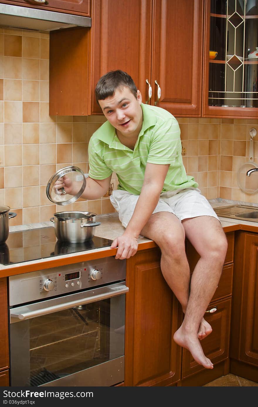 Young handsome guy in the kitchen