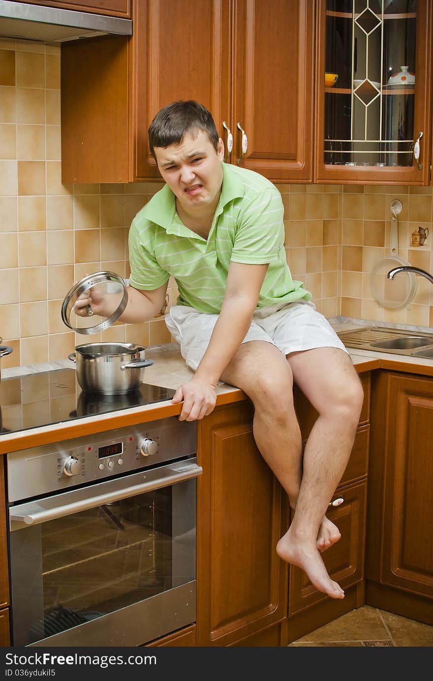 Young handsome guy in the kitchen