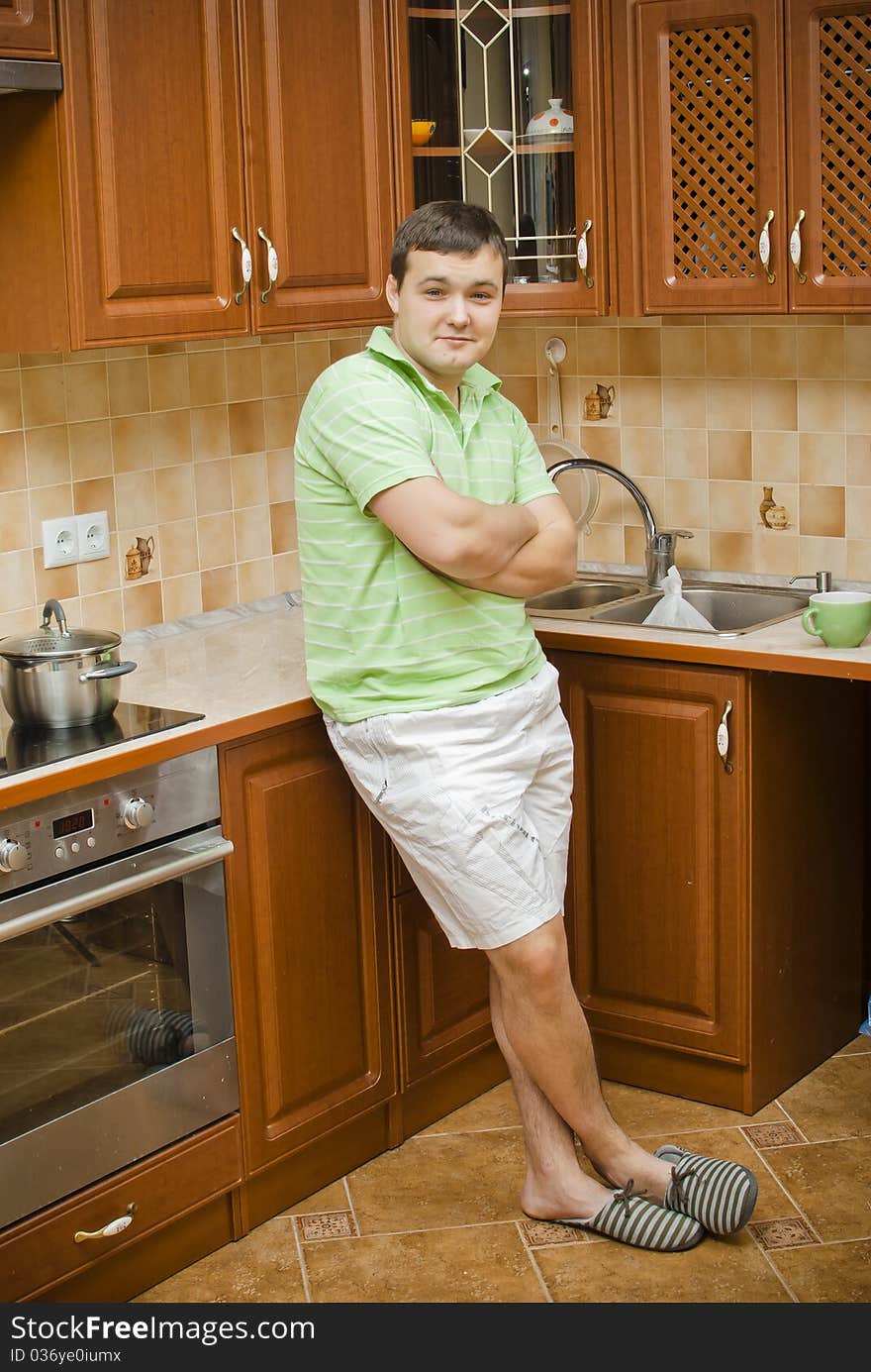 A young attractive man in the kitchen