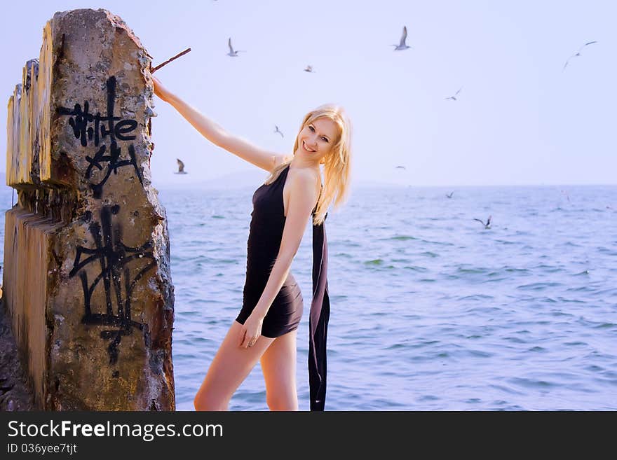 Blonde woman staying on ruins