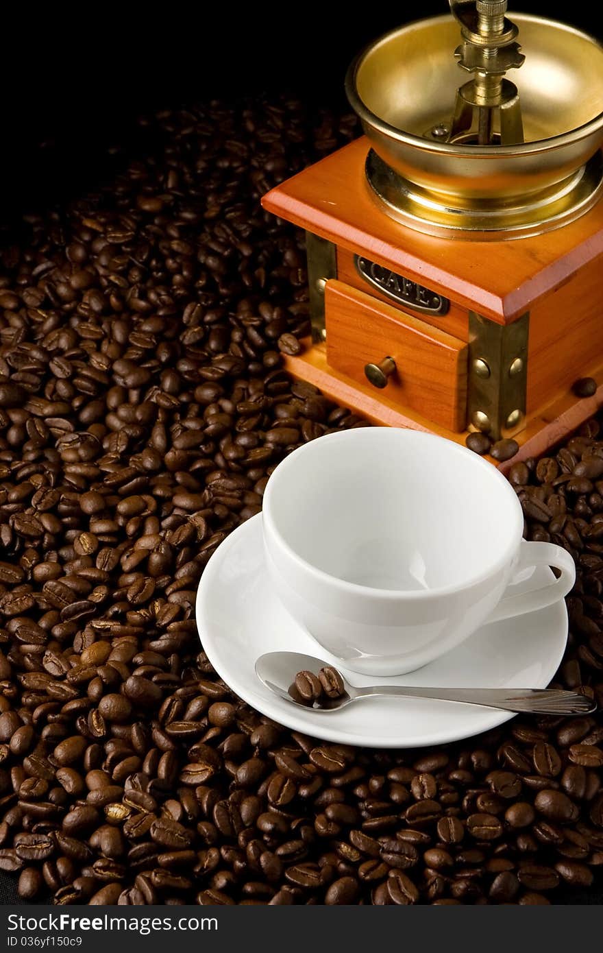 Empty Cup And Grinder On Coffee Beans