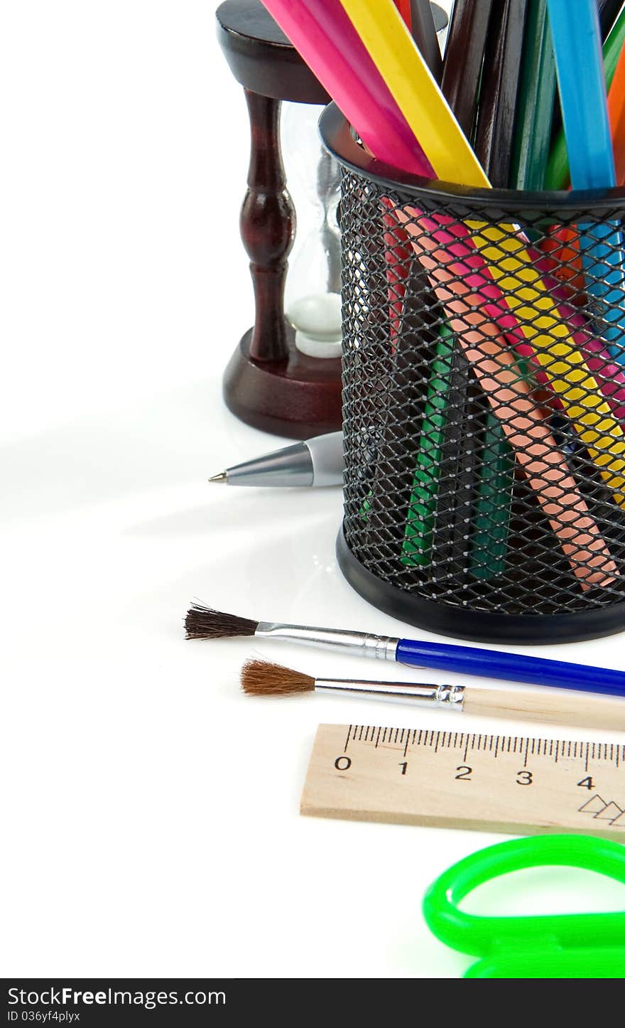 Paintbrush, pen and pencils in holder isolated on white background. Paintbrush, pen and pencils in holder isolated on white background