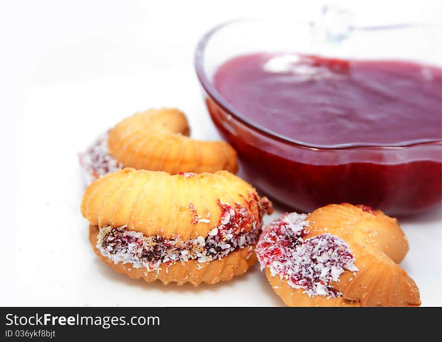 Butter biscuits and glass bowl with fruit jam