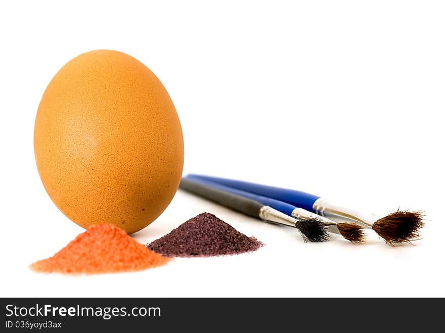 Easter accessories: egg, brushes and paint powders isolated on white background.