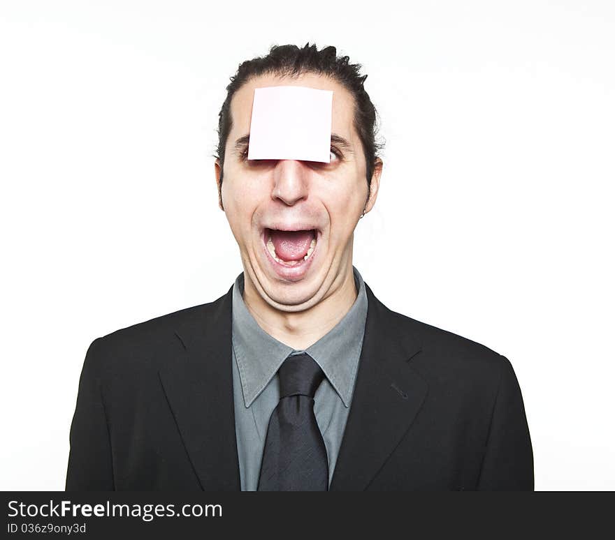 Young man with blank note on the face on white