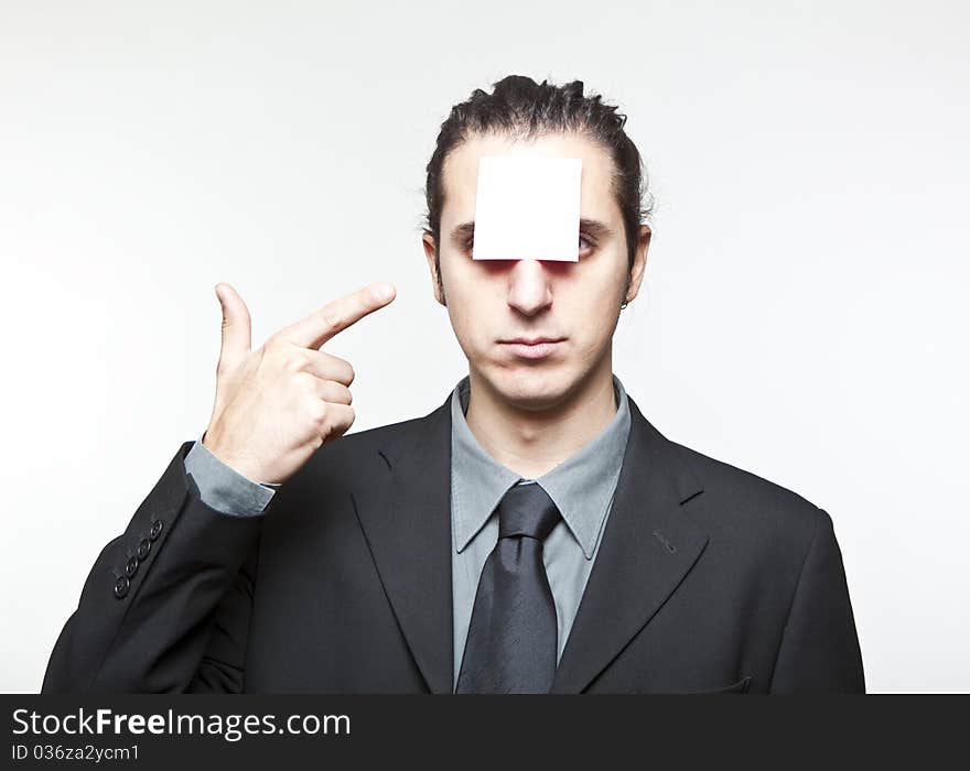 Young man with blank note on the face on white