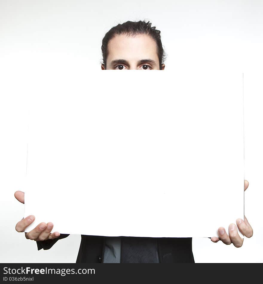 Businessman holding a blank sign in front oh his face