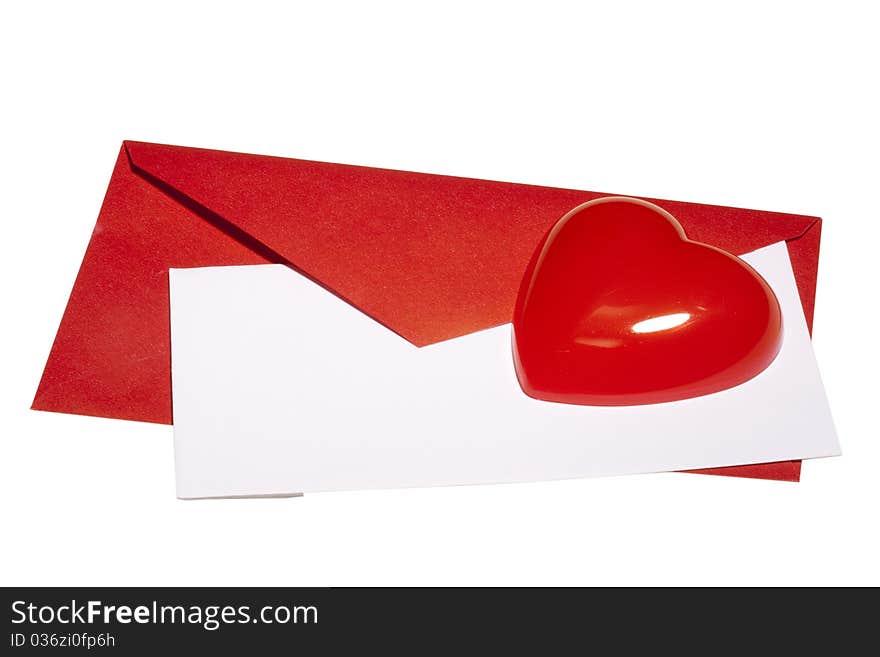 Red heart laying next to a red envelope with white paper on a white background. Red heart laying next to a red envelope with white paper on a white background.