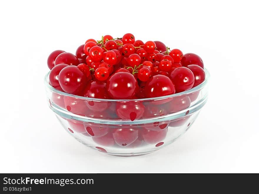 Sweet cherry and red currants in glass bowl isolated on white. Sweet cherry and red currants in glass bowl isolated on white