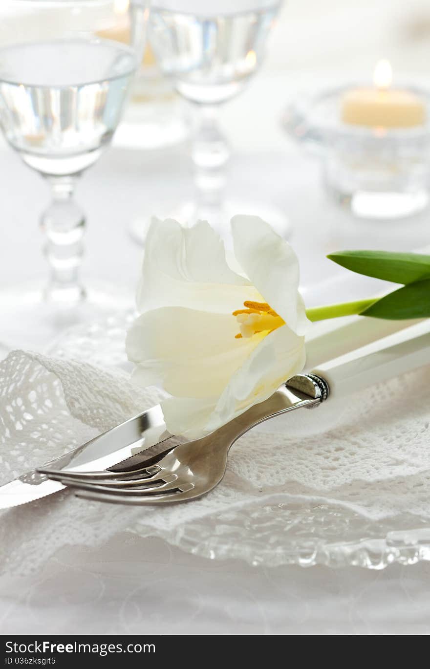 Place-setting With White Tulip And Napkin