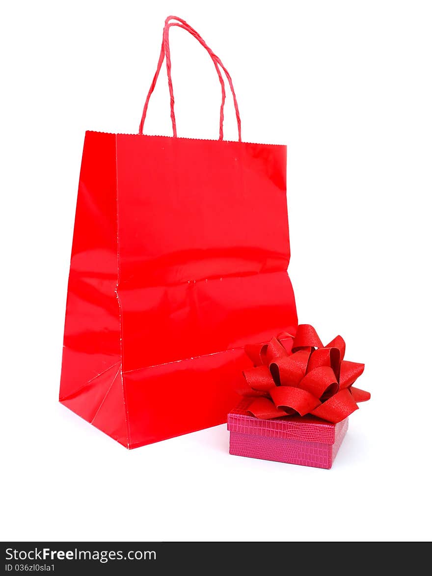 A gift wrapped box in a red bag