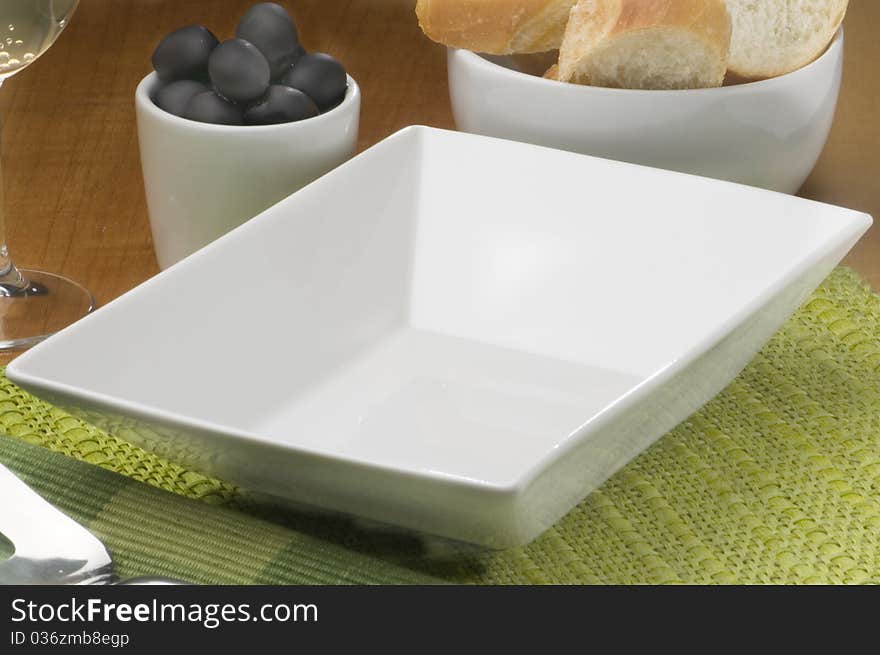 Empty white plate with decoration of olives and bread. Empty white plate with decoration of olives and bread