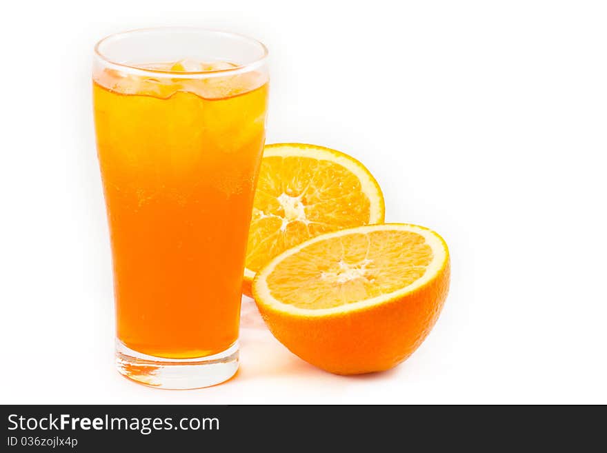 Orange juice in glass with half cut fresh oranges