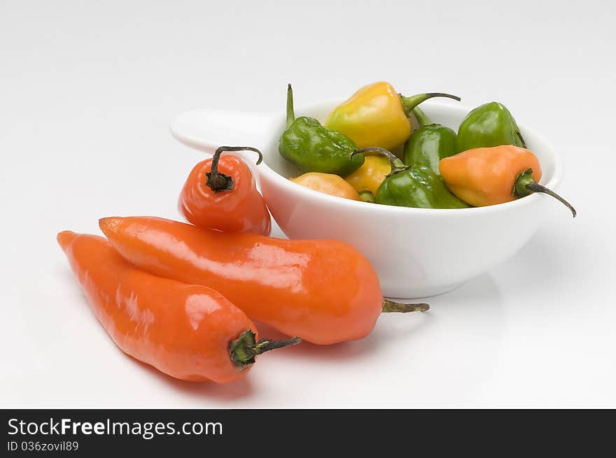 Sharp red pepper red and green peppers in white bottom. Sharp red pepper red and green peppers in white bottom