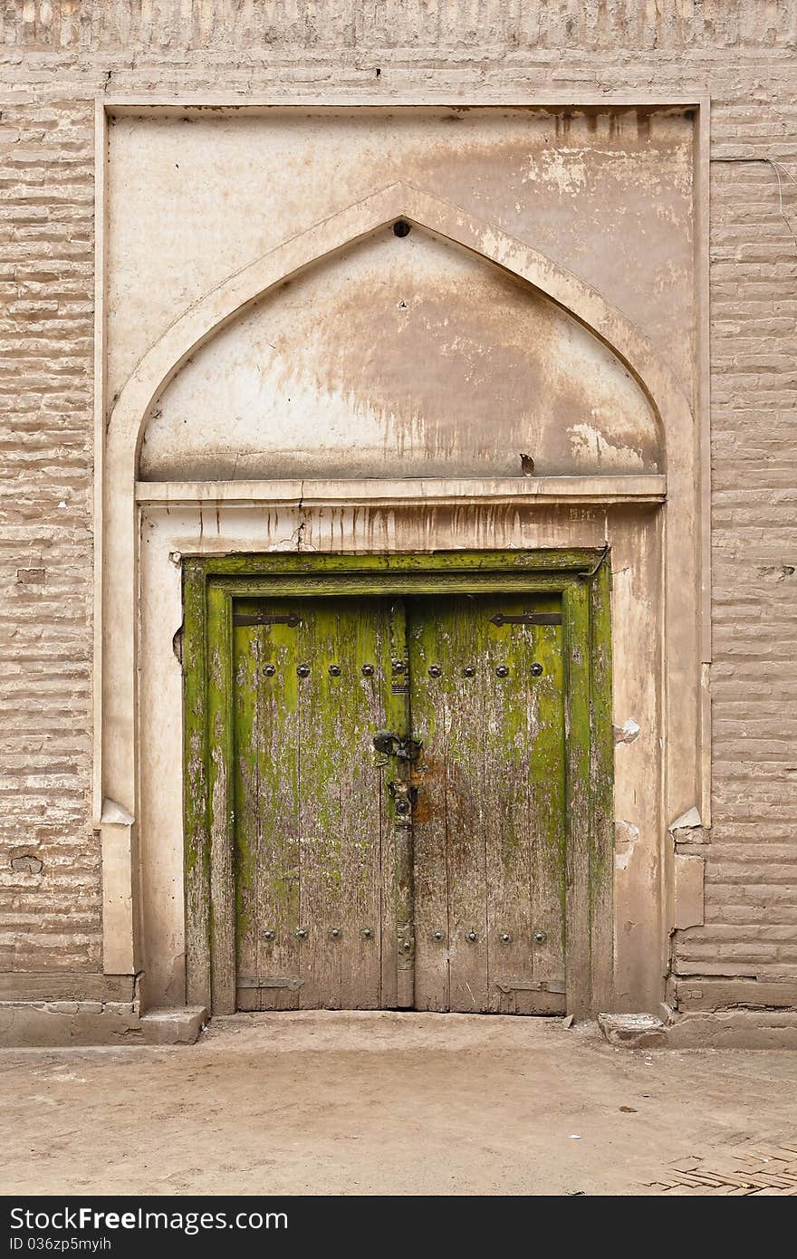 Locked double door of an uygur residential building in kashgar (or kashi), xinjiang uygur autonomous region, china. Locked double door of an uygur residential building in kashgar (or kashi), xinjiang uygur autonomous region, china.