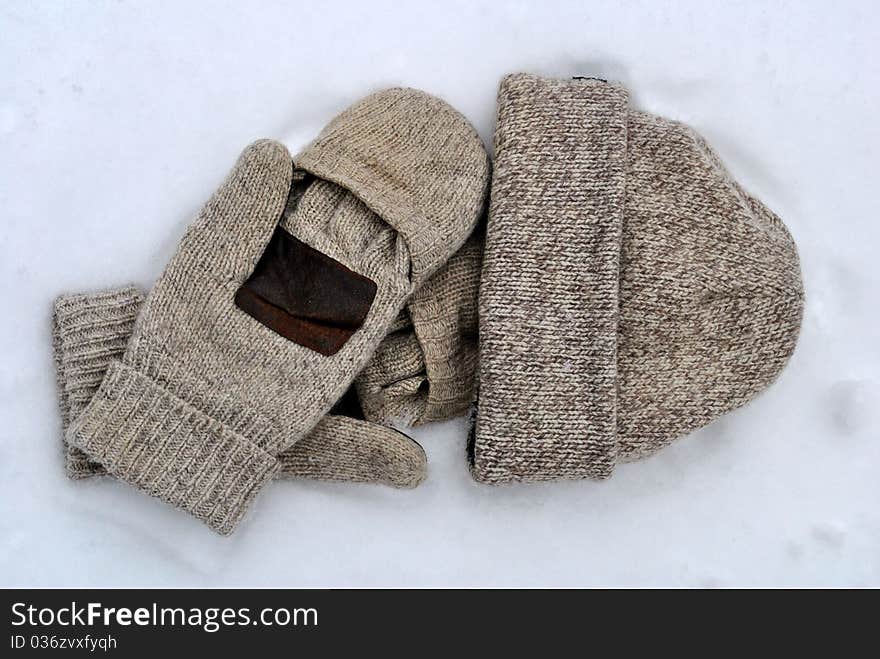 A pair of brown wool mittens and a wool hat. A pair of brown wool mittens and a wool hat