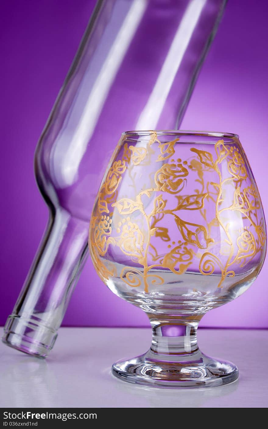 Design glass decorated in gold on purple background. Design glass decorated in gold on purple background